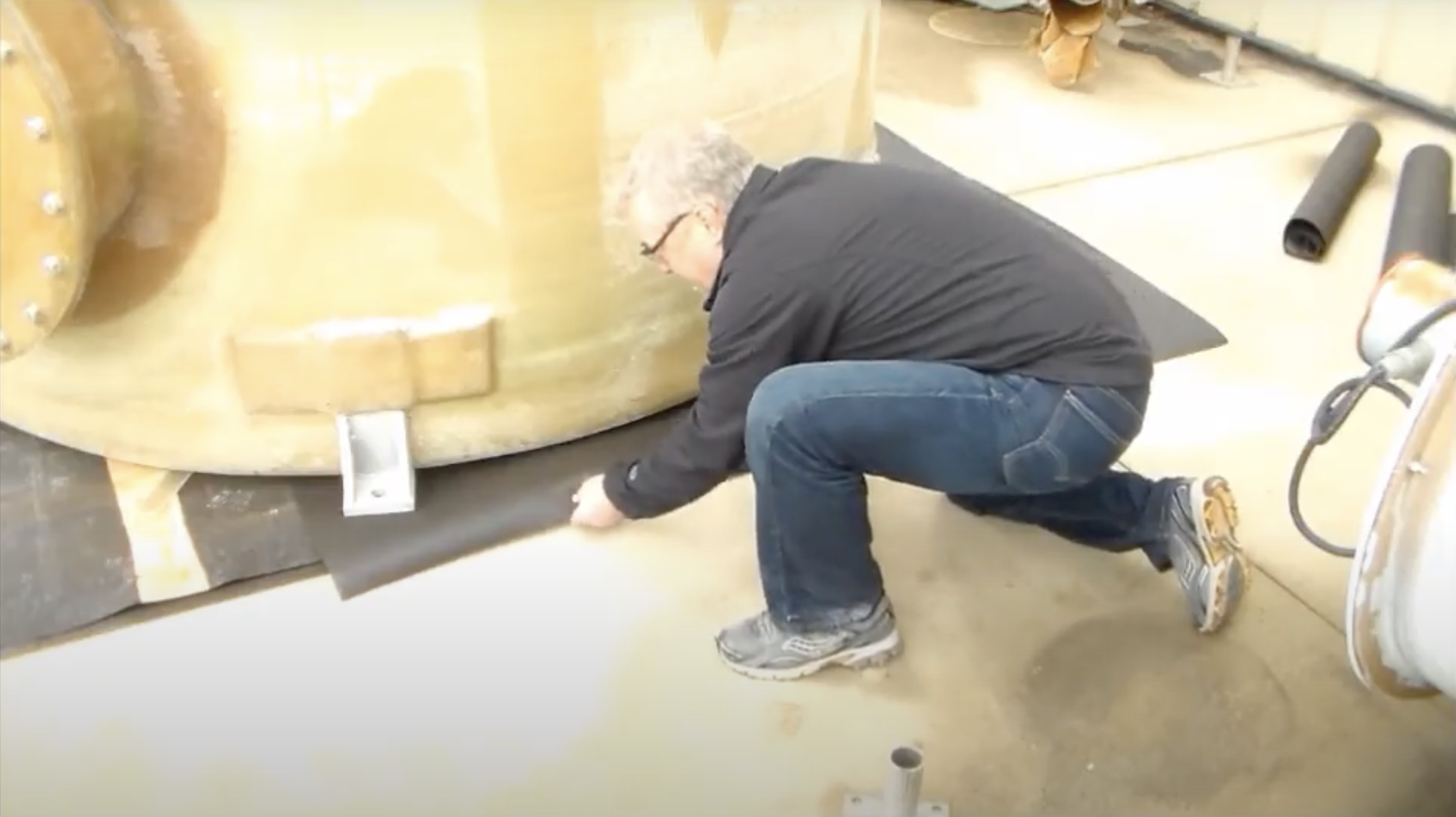 A design tanks employee demonstrates how to shim a tank